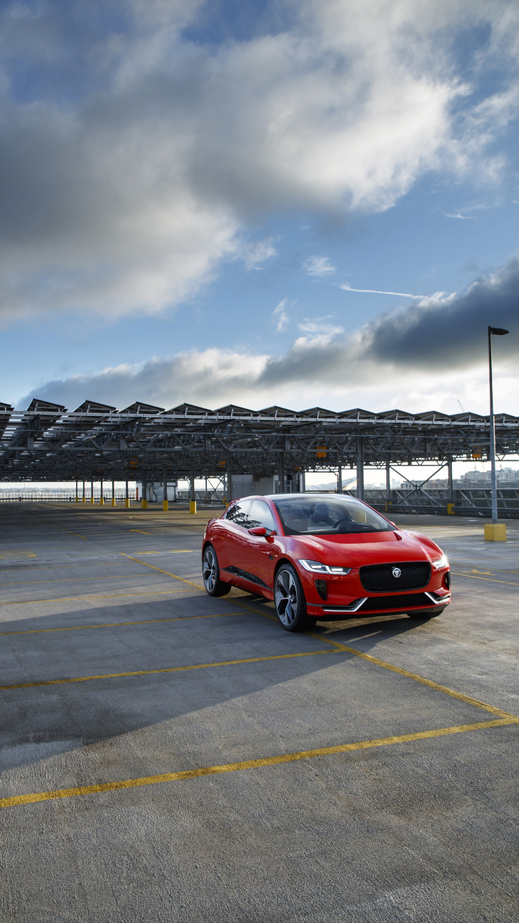 Red Car on Gray Asphalt Road Under Gray Cloudy Sky During Daytime. Wallpaper in 750x1334 Resolution