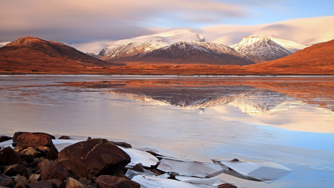 Brown and White Mountains Near Body of Water During Daytime. Wallpaper in 1366x768 Resolution
