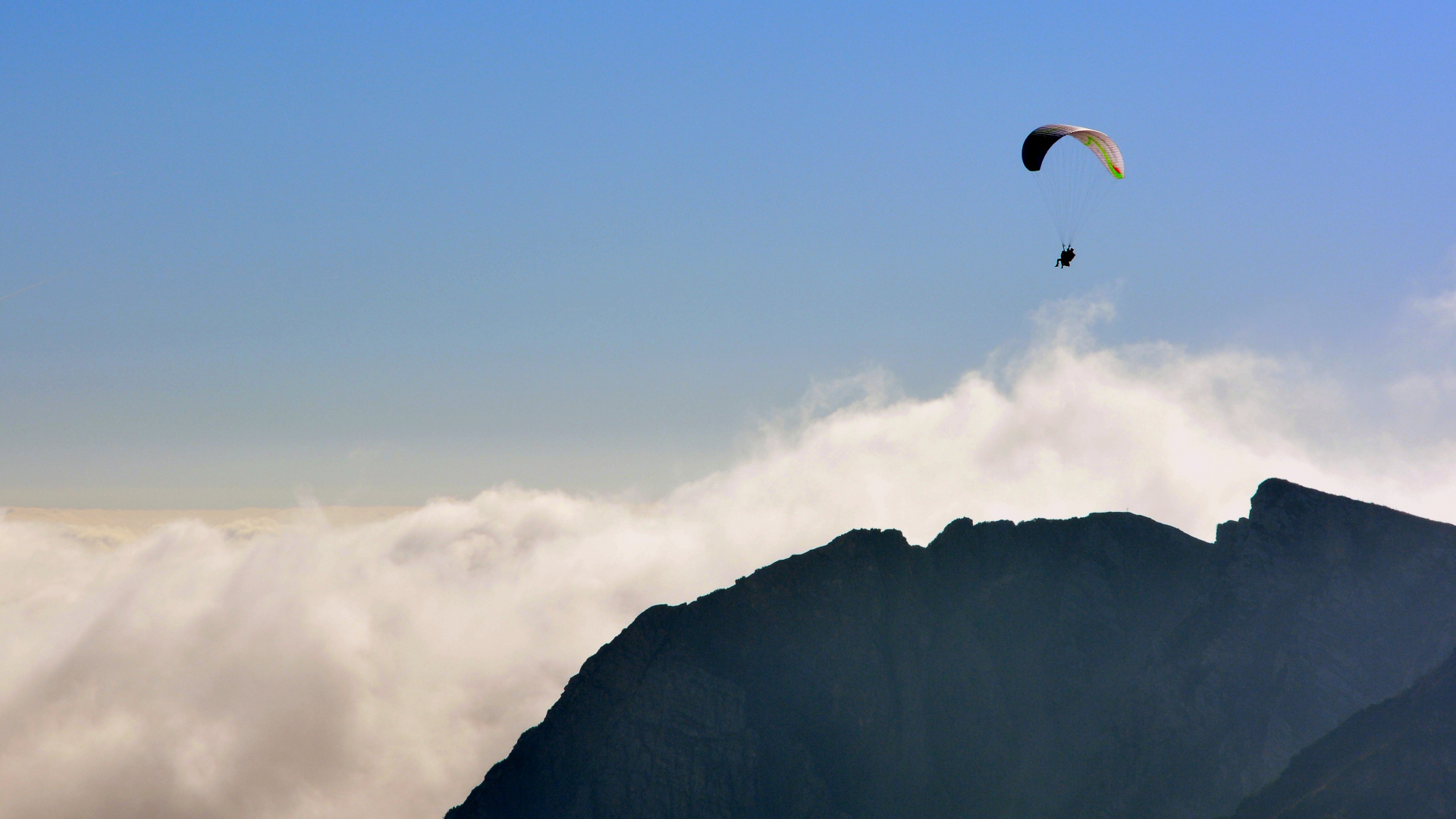 Person Riding Parachute Over Mountain. Wallpaper in 1920x1080 Resolution