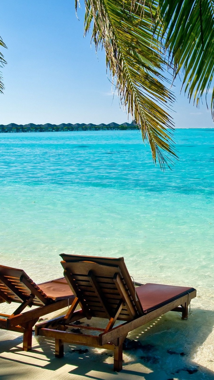 Brown Wooden Lounge Chairs on Beach During Daytime. Wallpaper in 720x1280 Resolution