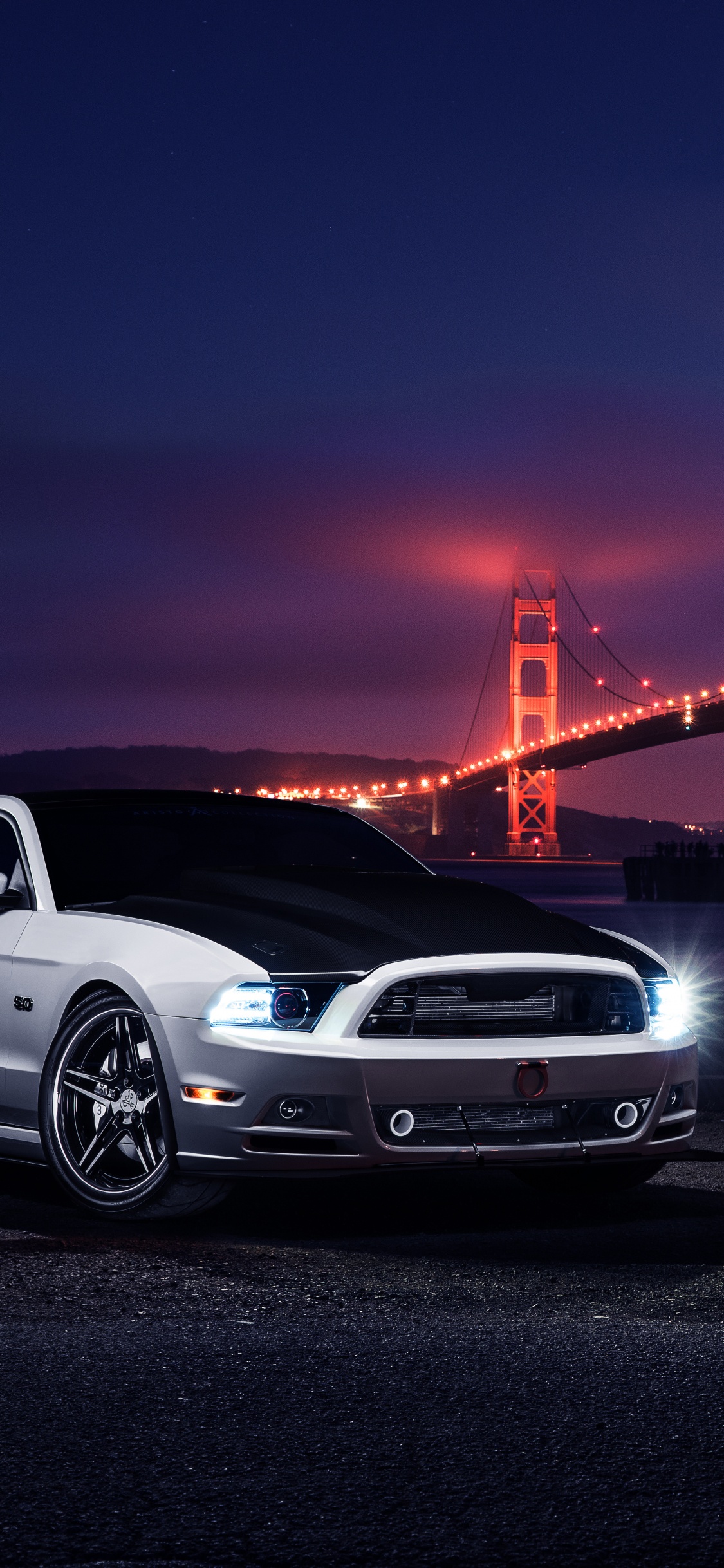 White Porsche 911 Parked Near Golden Gate Bridge During Night Time. Wallpaper in 1125x2436 Resolution