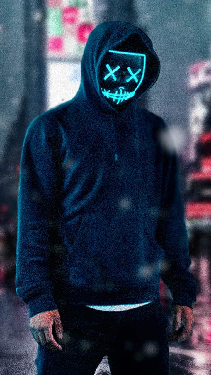 Man in Blue Hoodie and Black Pants Wearing Black Mask Standing on Street During Daytime. Wallpaper in 720x1280 Resolution