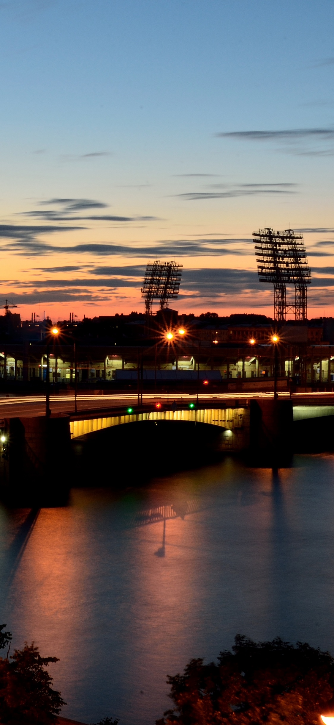 Body of Water Near Bridge During Night Time. Wallpaper in 1125x2436 Resolution