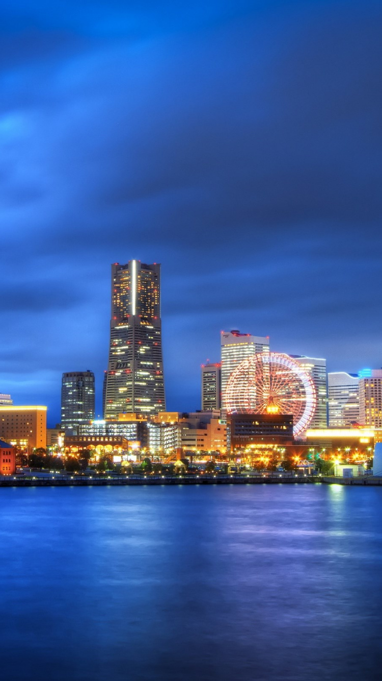 City Skyline Across Body of Water During Night Time. Wallpaper in 750x1334 Resolution