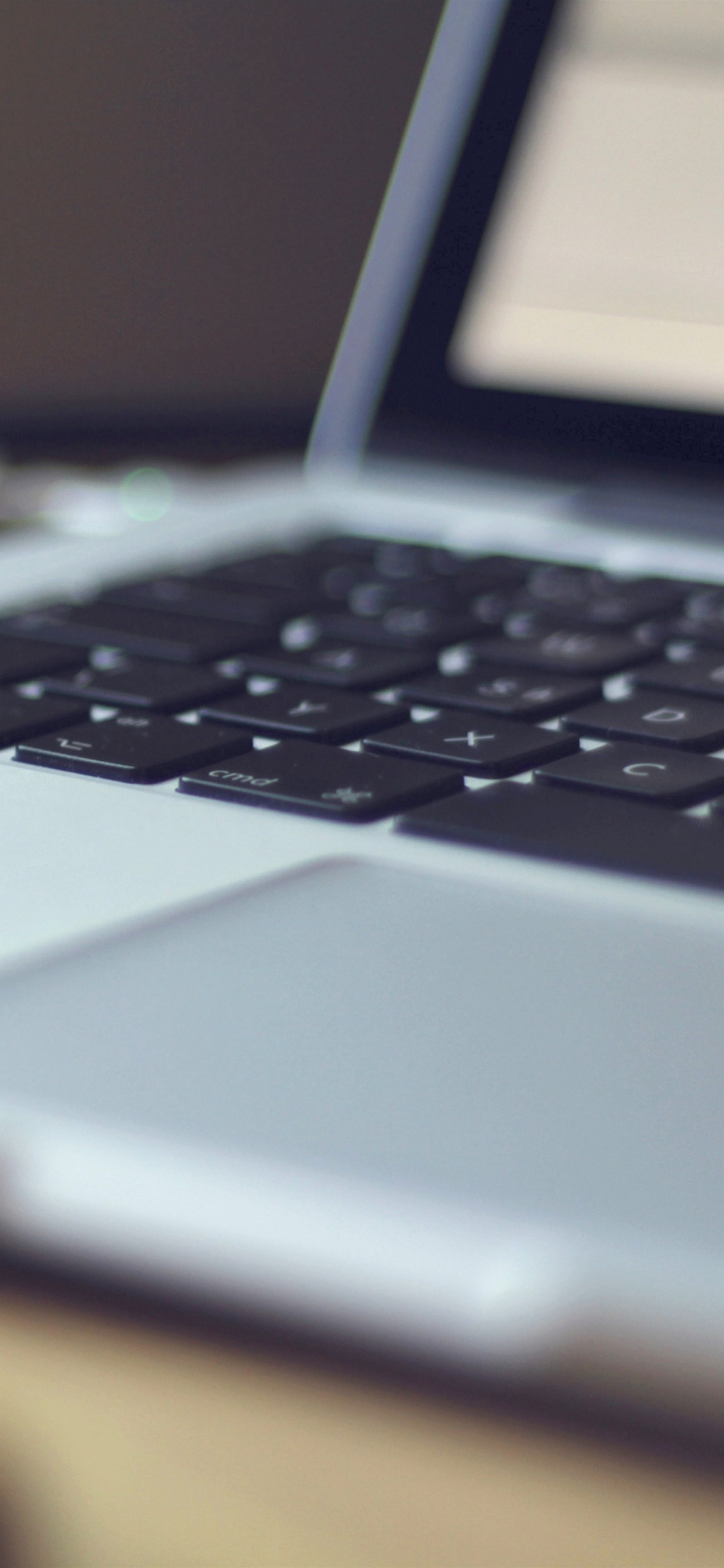 Macbook Pro on Brown Wooden Table. Wallpaper in 1125x2436 Resolution