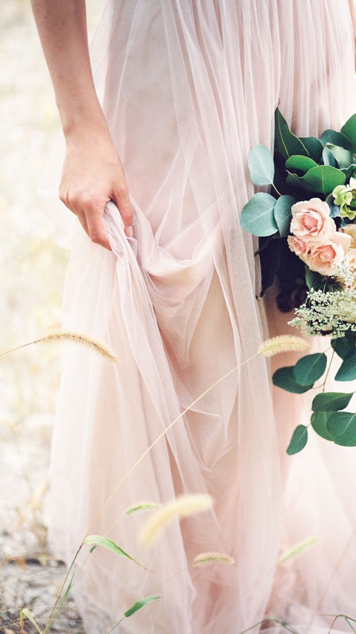 Woman in White Dress Holding White and Green Flower Bouquet. Wallpaper in 720x1280 Resolution