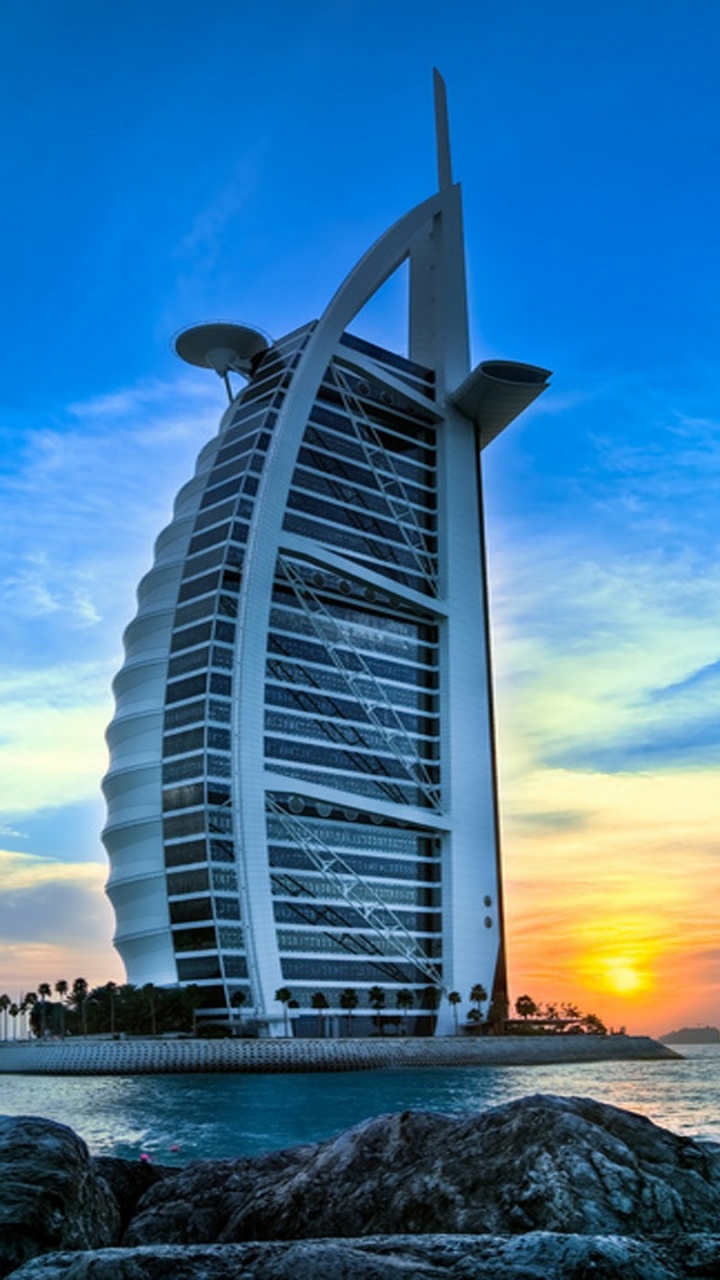 White and Gray Building Near Body of Water During Sunset. Wallpaper in 720x1280 Resolution
