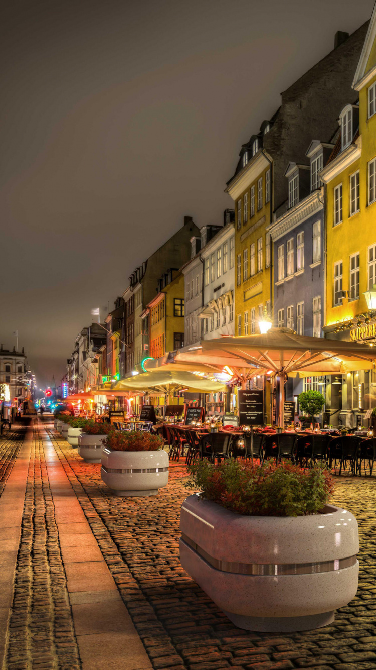 People Walking on Street Near Buildings During Nighttime. Wallpaper in 750x1334 Resolution