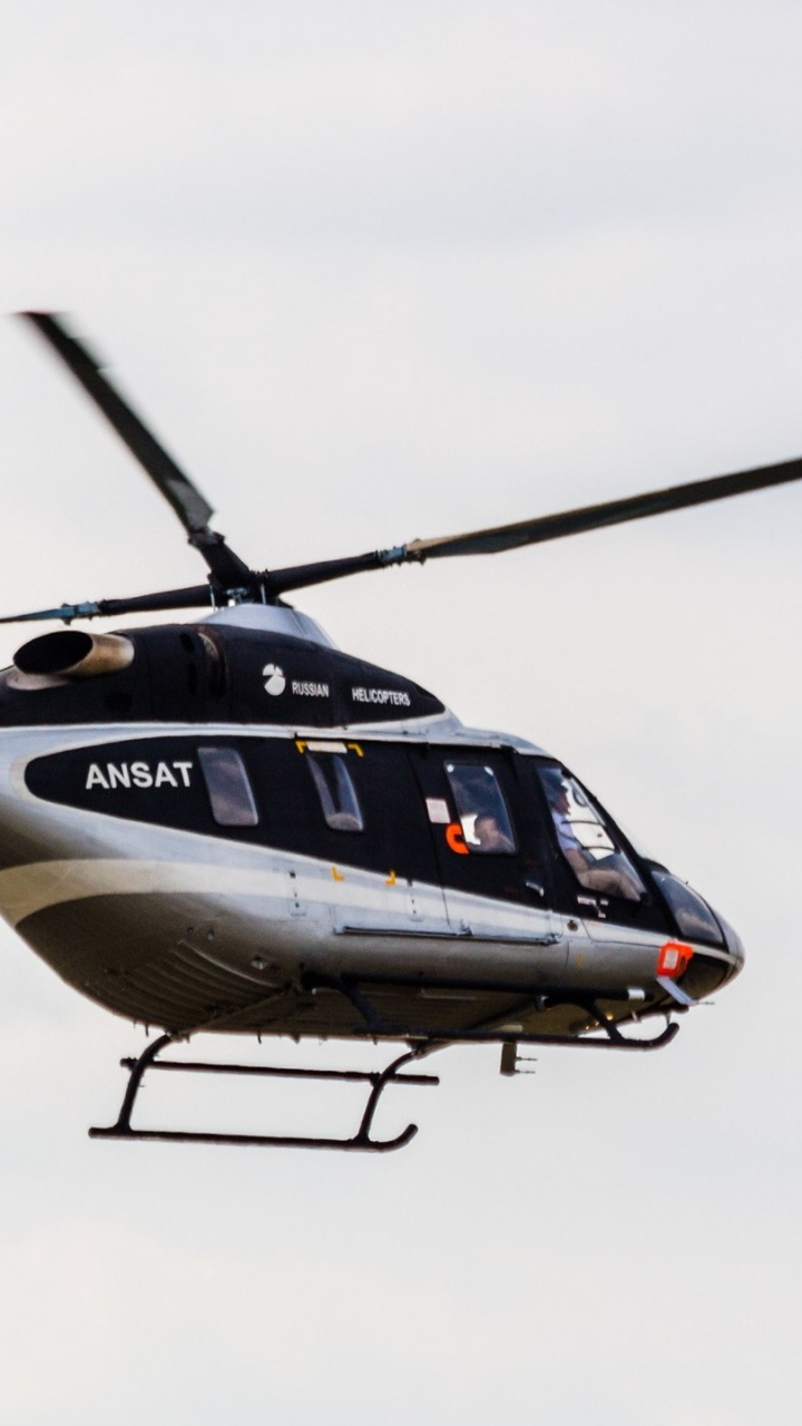 White and Blue Helicopter Flying in The Sky. Wallpaper in 720x1280 Resolution