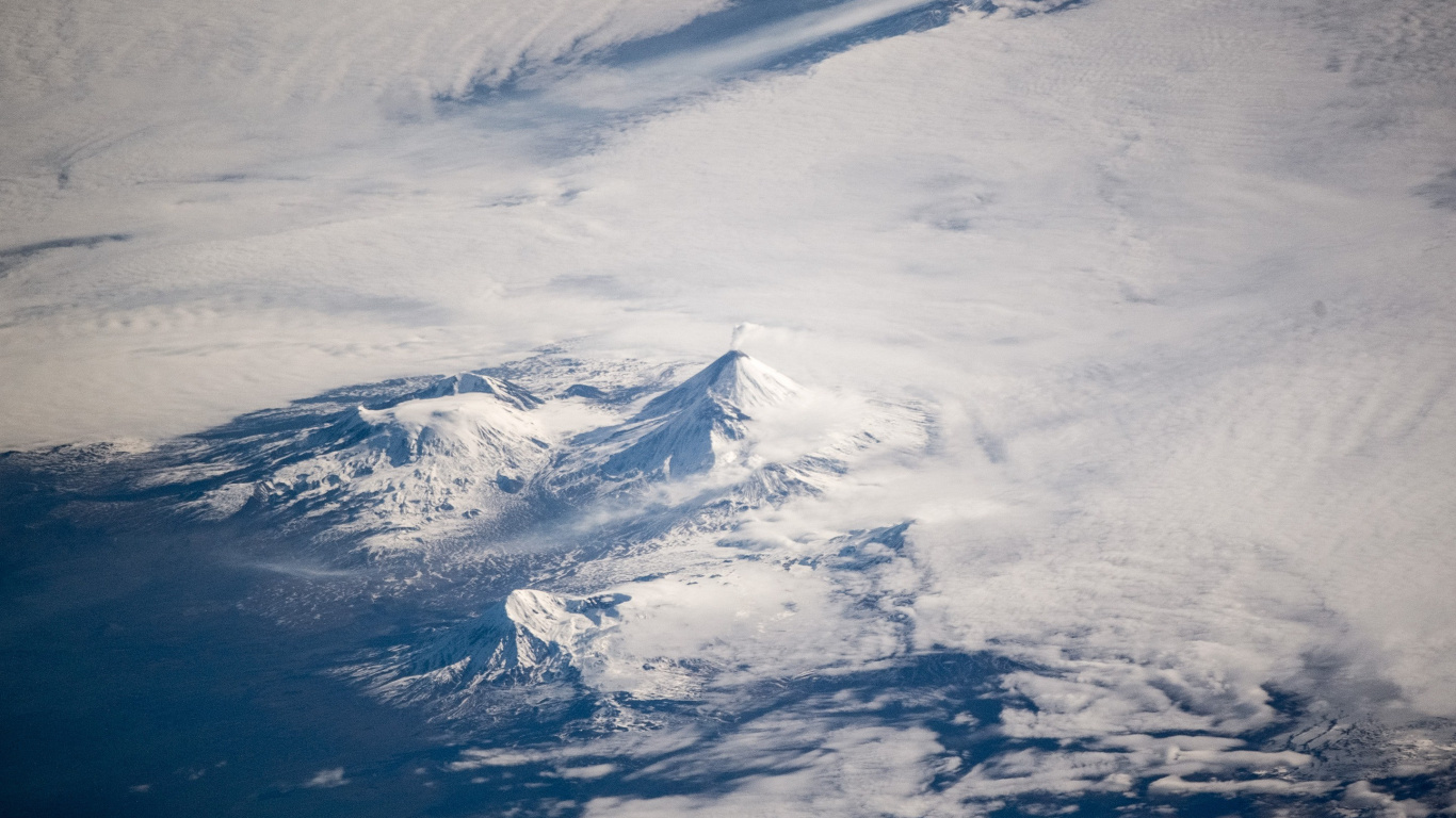 Snow Covered Mountain Under Cloudy Sky During Daytime. Wallpaper in 1366x768 Resolution