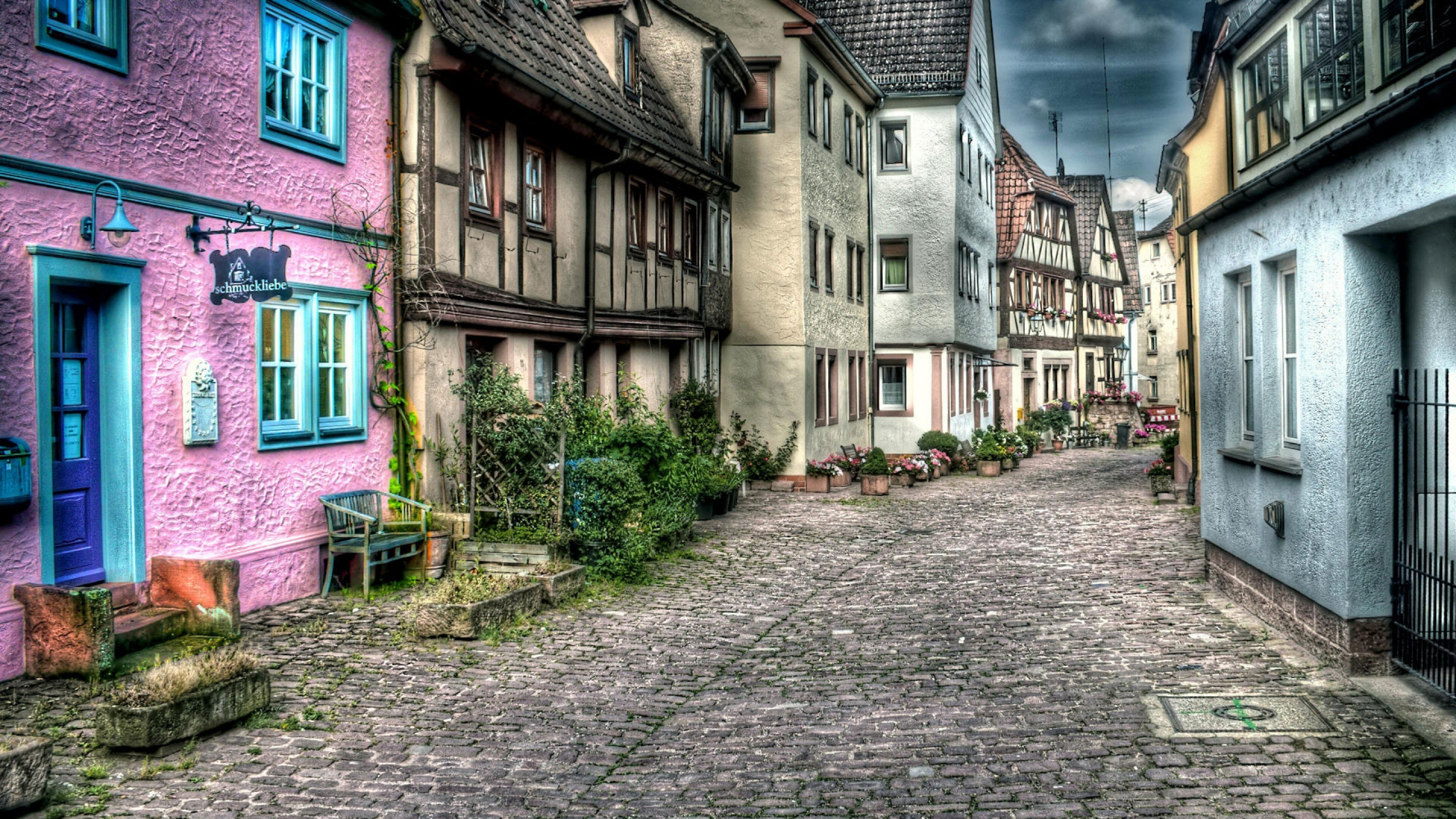 Brown Brick Pathway Between Houses During Daytime. Wallpaper in 2560x1440 Resolution
