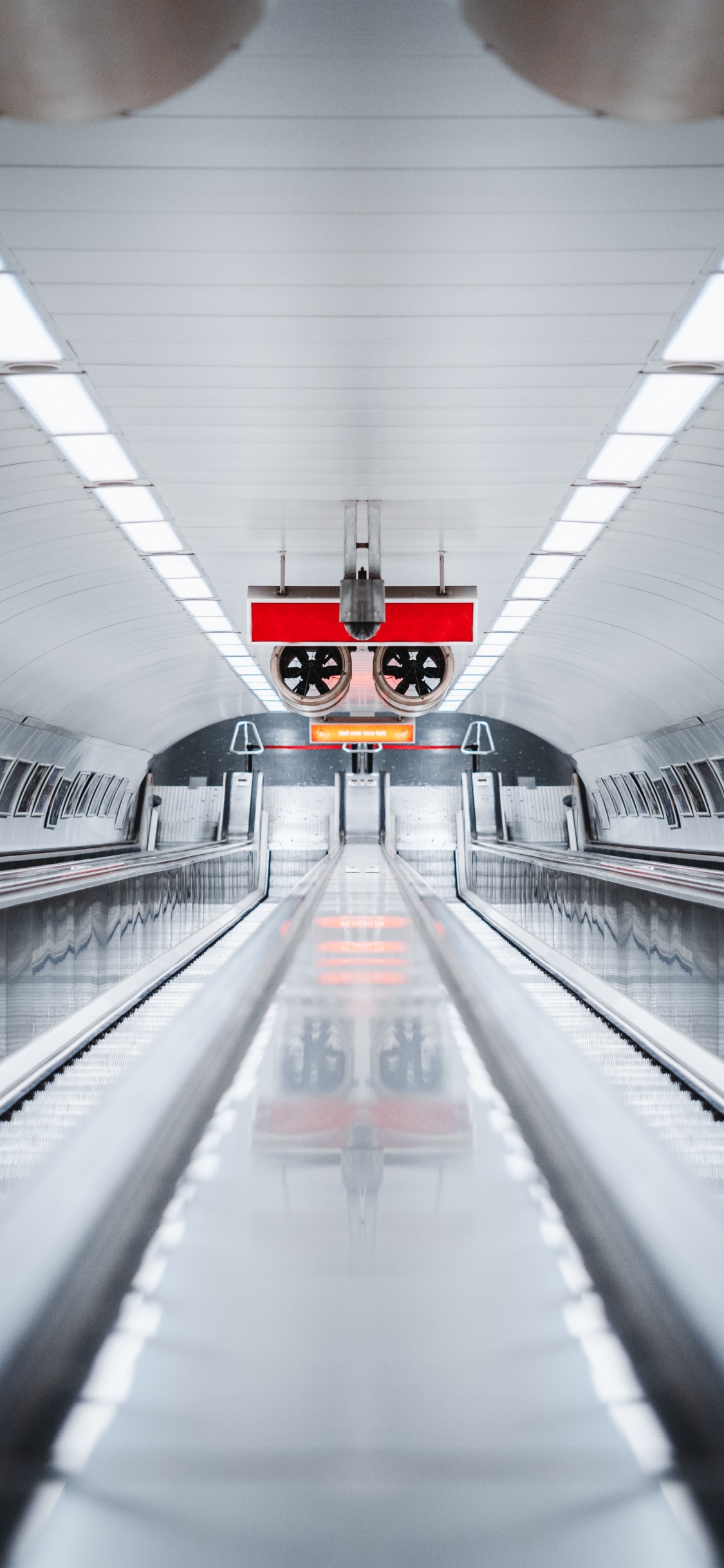 Red and White Train in Tunnel. Wallpaper in 1125x2436 Resolution