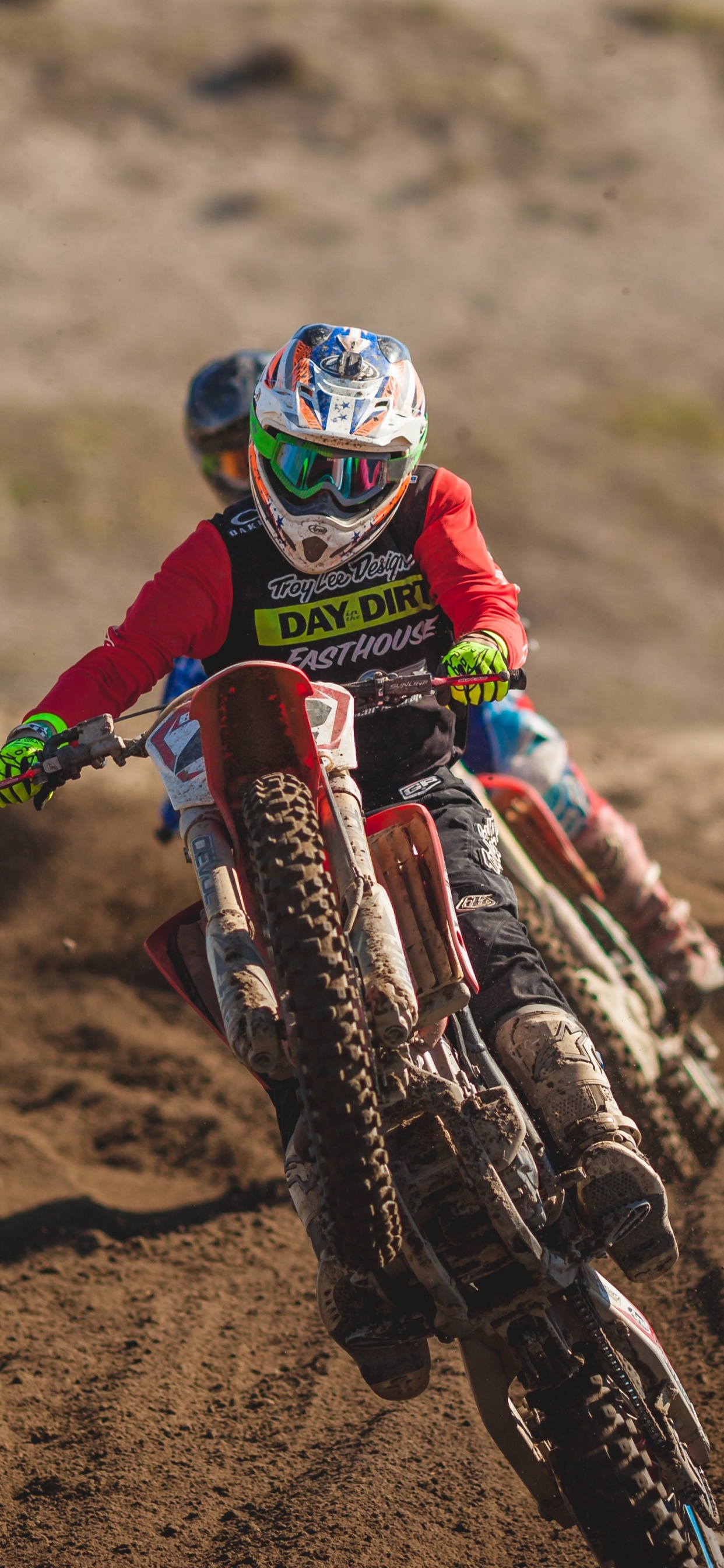 Man in Green and Black Motocross Suit Riding Motocross Dirt Bike. Wallpaper in 1242x2688 Resolution