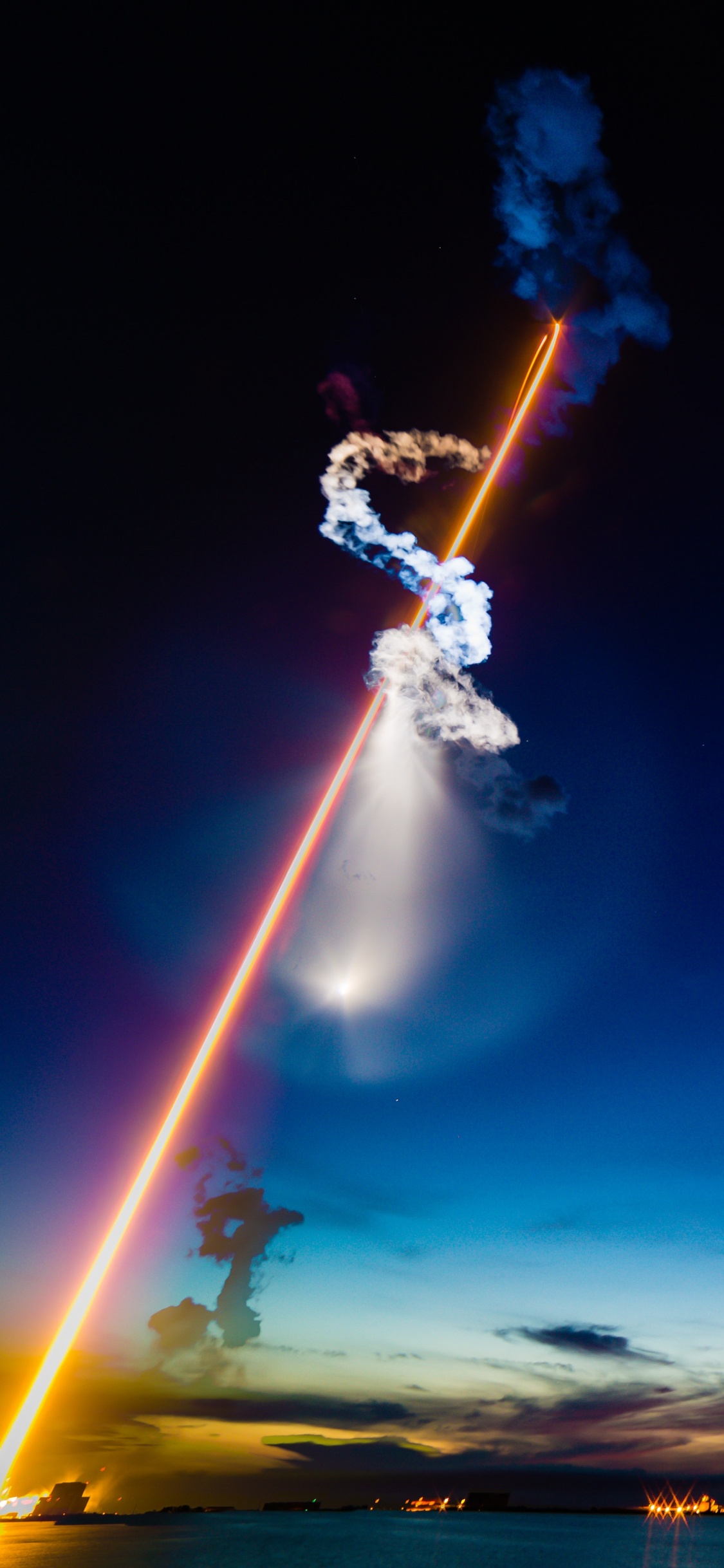 Man in White Shirt and Blue Denim Jeans Holding Fire Hose. Wallpaper in 1125x2436 Resolution