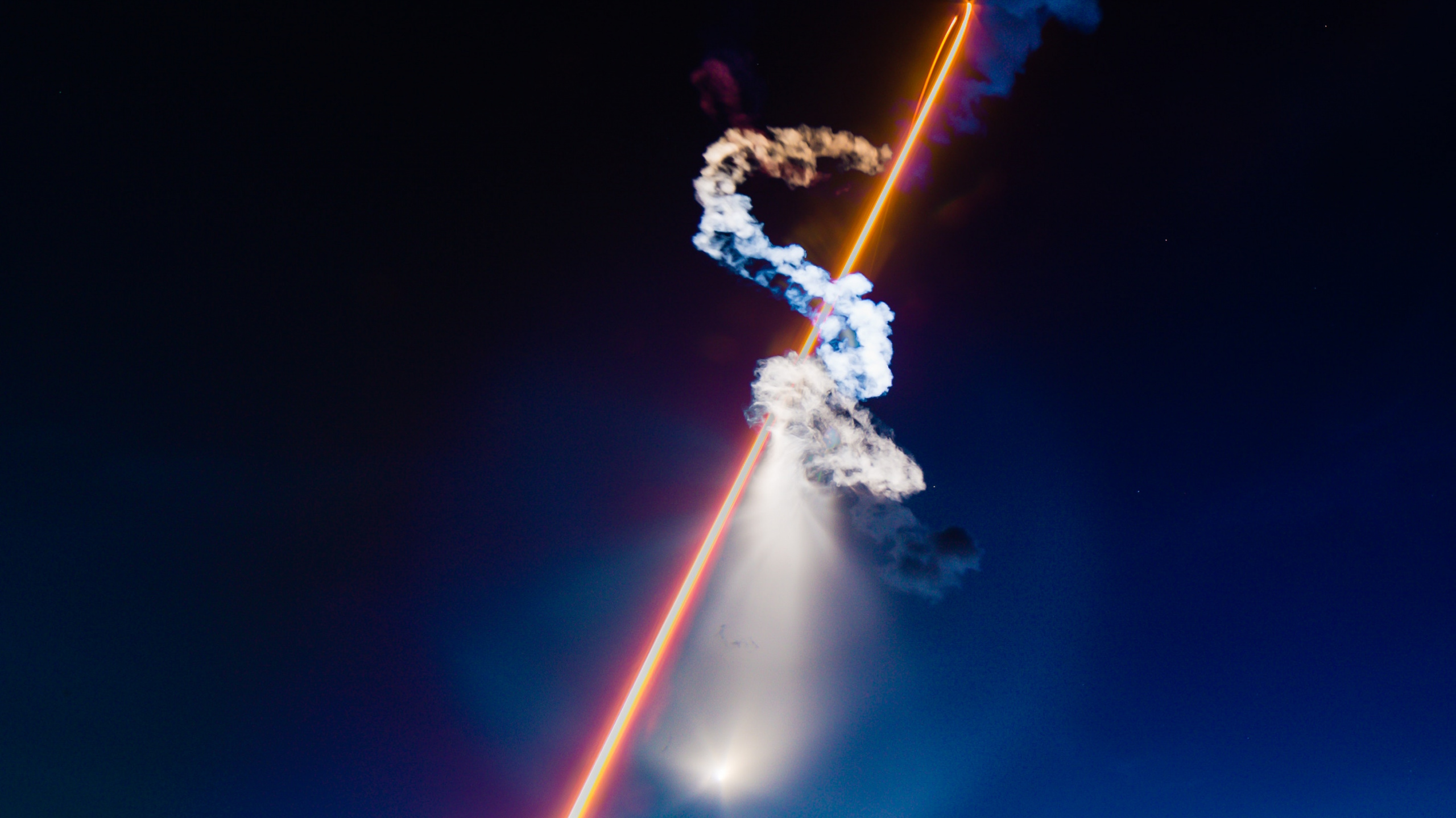 Man in White Shirt and Blue Denim Jeans Holding Fire Hose. Wallpaper in 2560x1440 Resolution