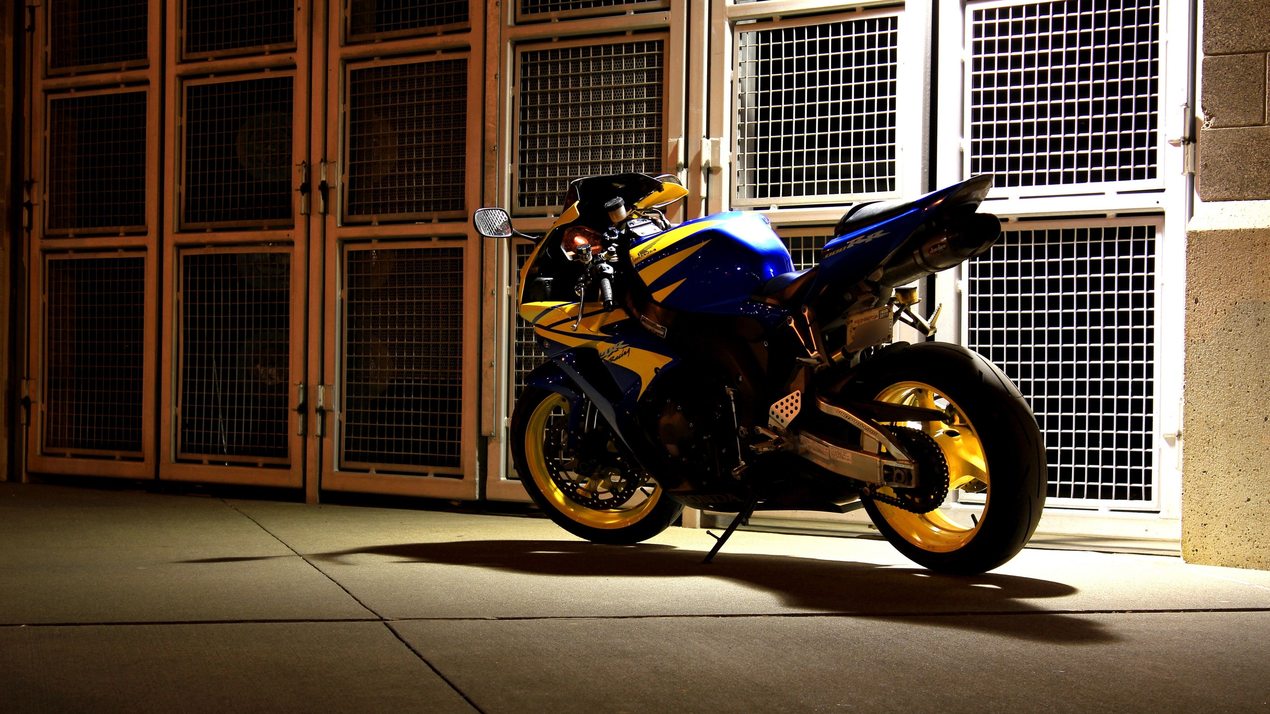 Blue and Black Sports Bike Parked Beside Brown Wooden Door. Wallpaper in 2560x1440 Resolution