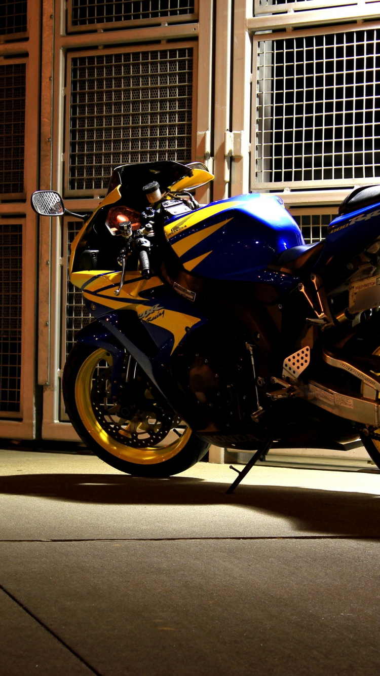 Blue and Black Sports Bike Parked Beside Brown Wooden Door. Wallpaper in 750x1334 Resolution
