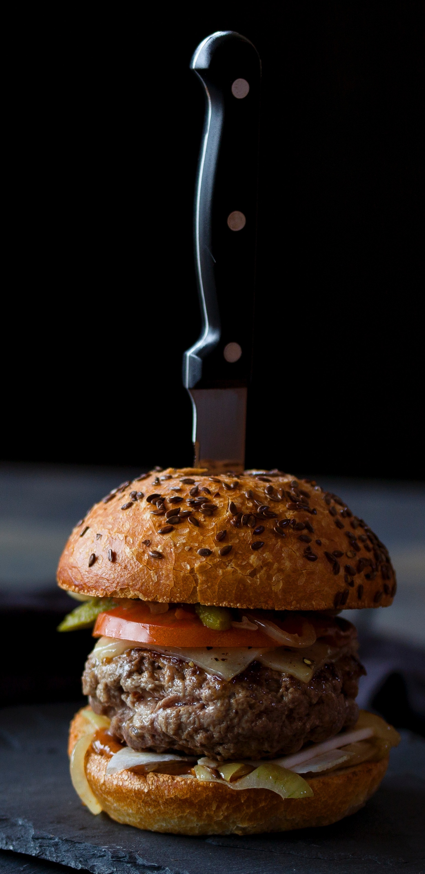 Burger on Black Leather Textile. Wallpaper in 1440x2960 Resolution