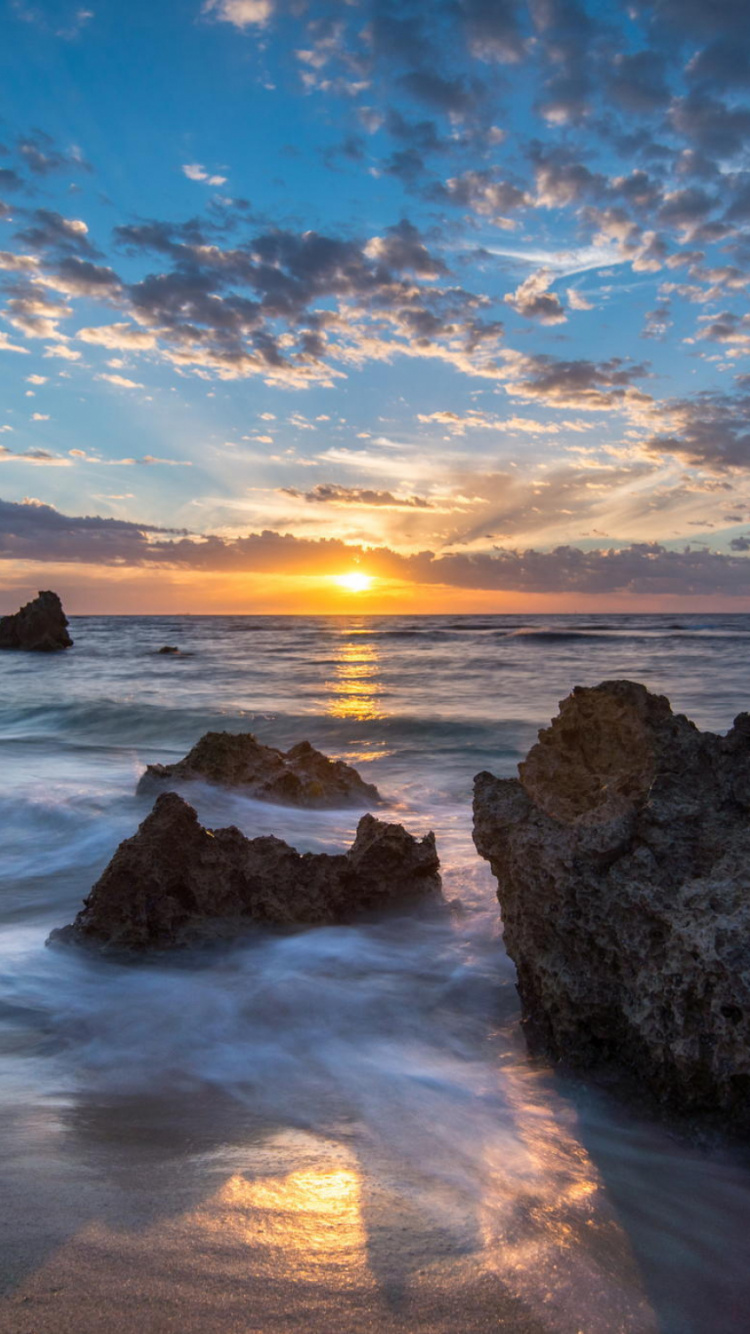Rocky Shore Under Blue Sky During Sunset. Wallpaper in 750x1334 Resolution