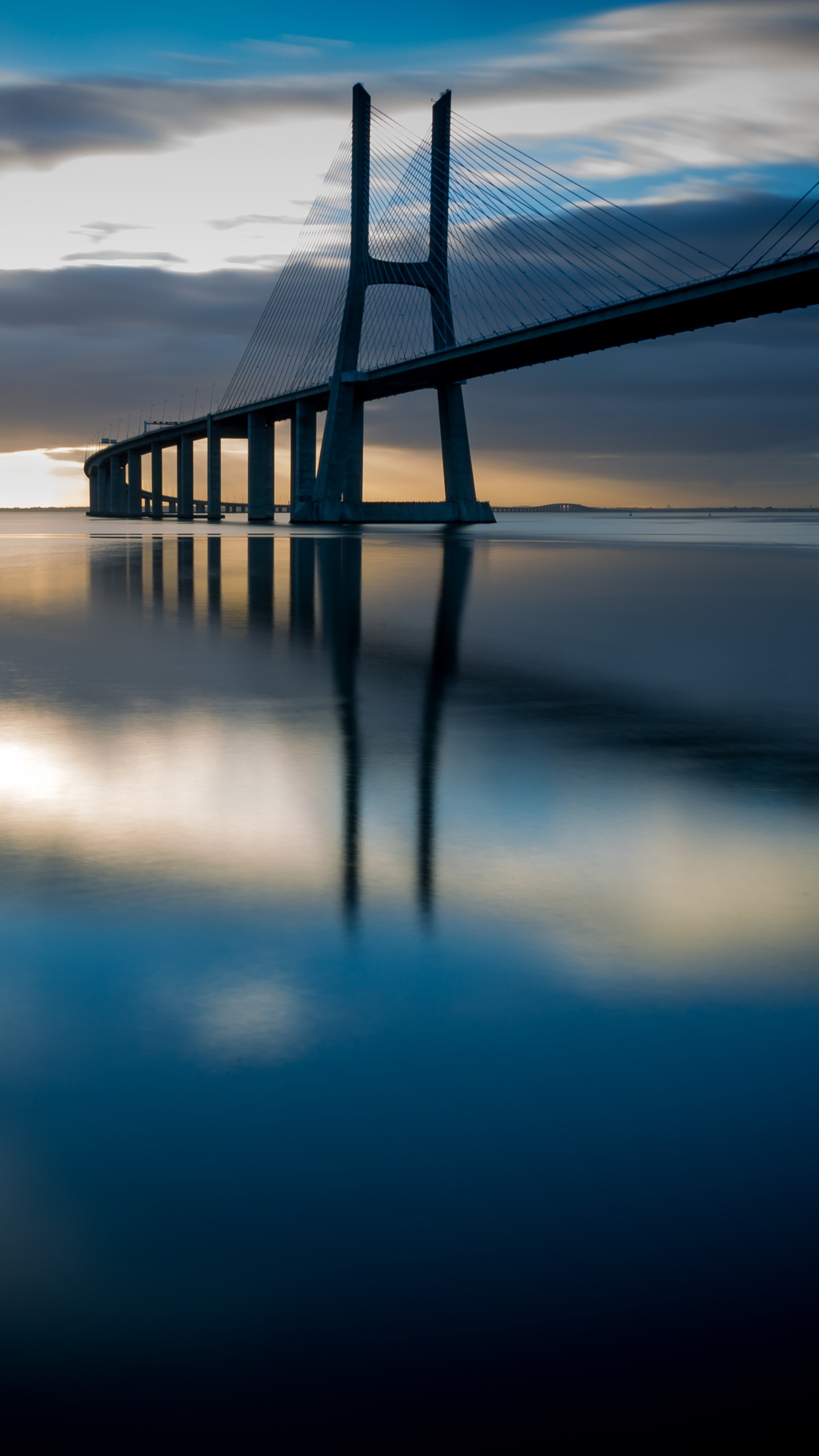 Bridge Over Water During Night Time. Wallpaper in 1440x2560 Resolution