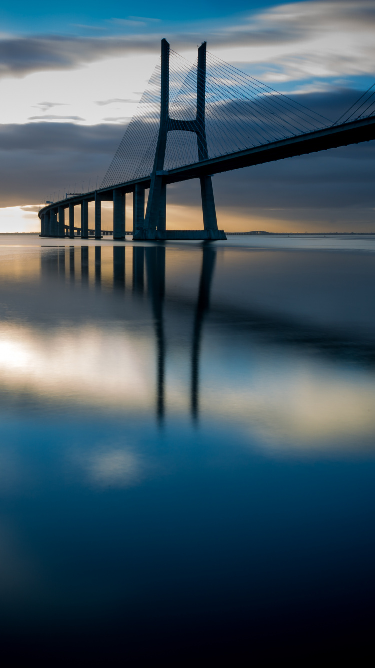 Bridge Over Water During Night Time. Wallpaper in 750x1334 Resolution