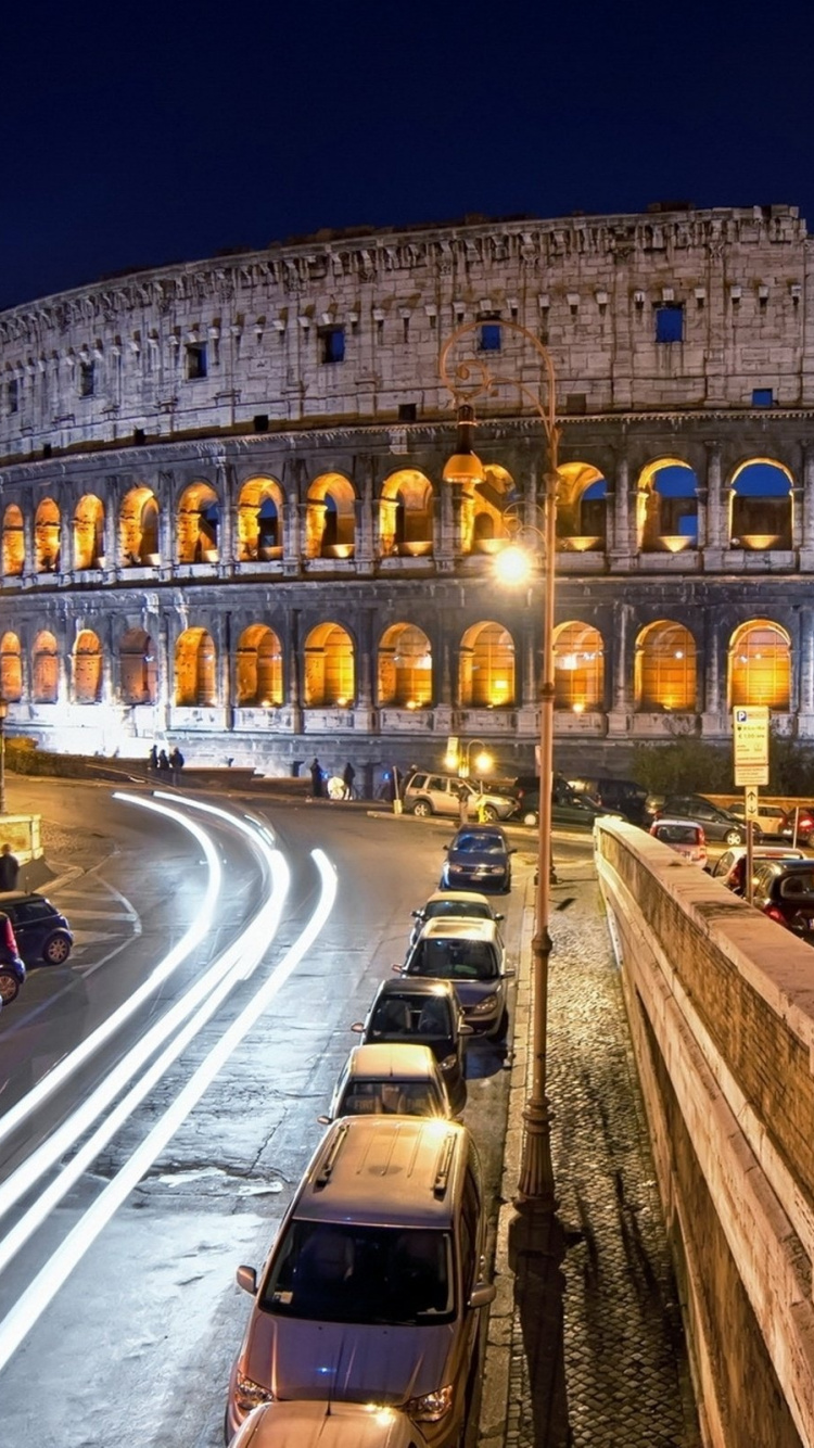 Cars on Road Near Brown Concrete Building During Night Time. Wallpaper in 750x1334 Resolution