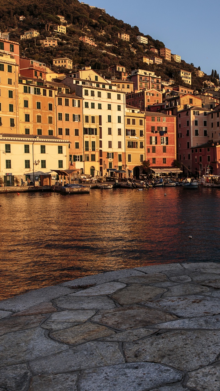 People Walking on Sidewalk Near Body of Water During Daytime. Wallpaper in 720x1280 Resolution