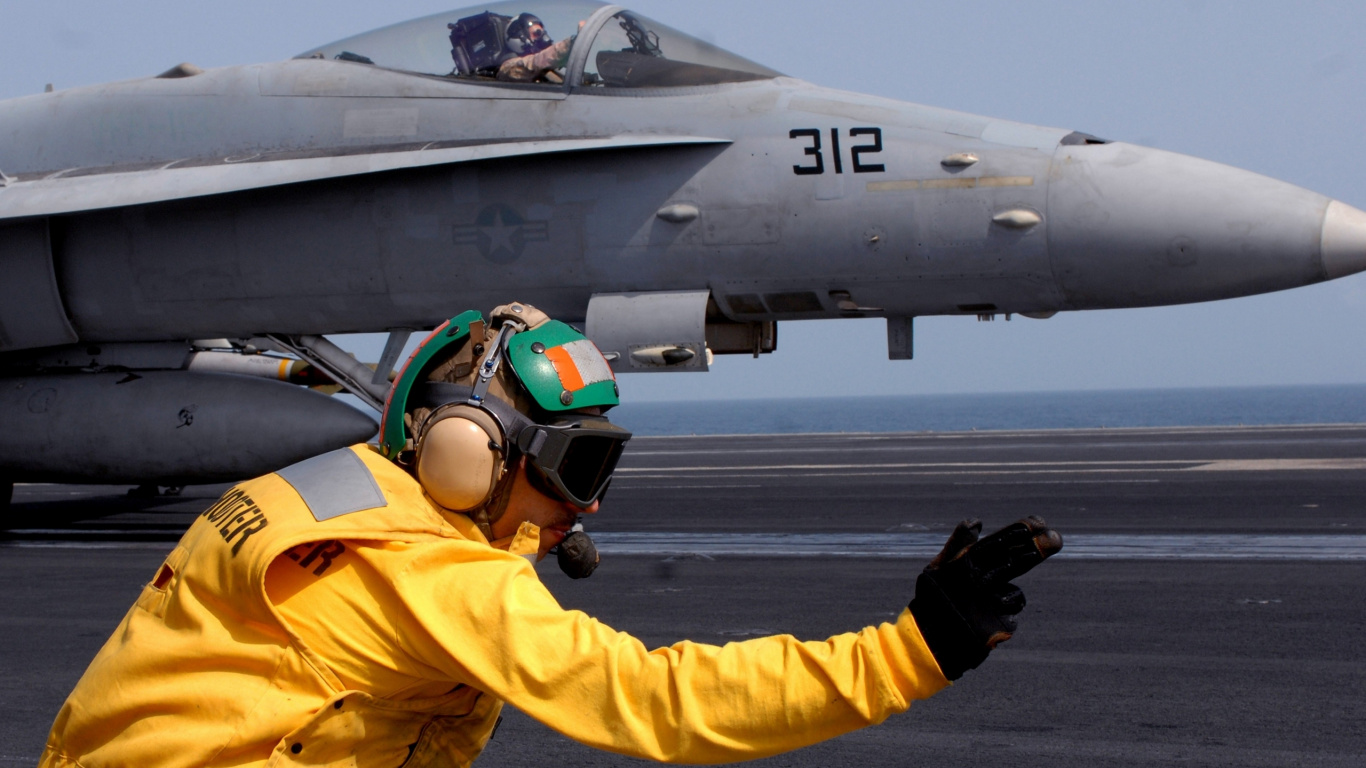 Man in Yellow Jacket and Helmet Riding on Gray Jet Plane. Wallpaper in 1366x768 Resolution