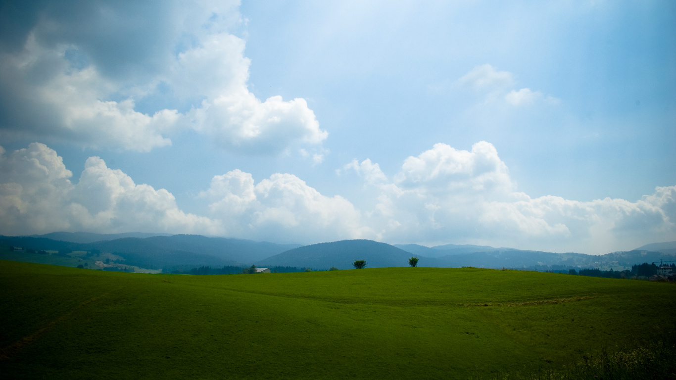 Green Grass Field Under White Clouds During Daytime. Wallpaper in 1366x768 Resolution