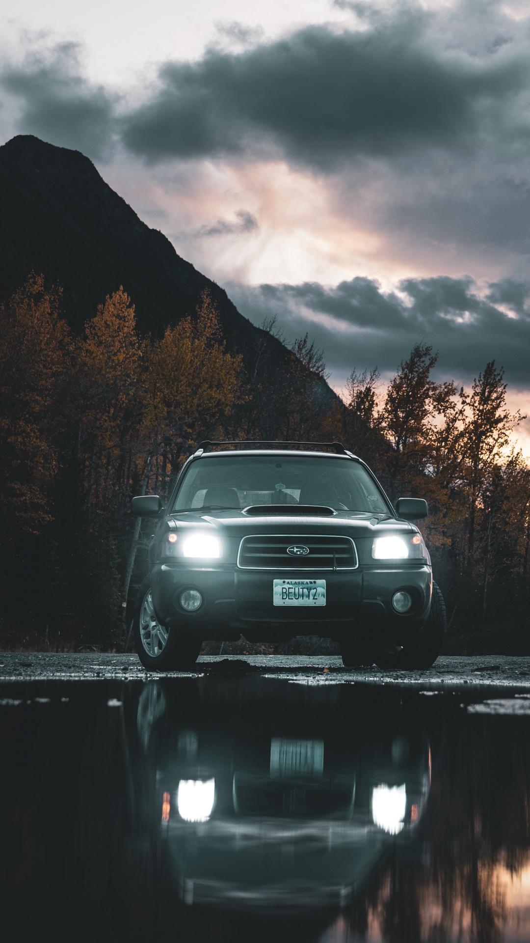 Black Car on Road Near Body of Water During Daytime. Wallpaper in 1080x1920 Resolution