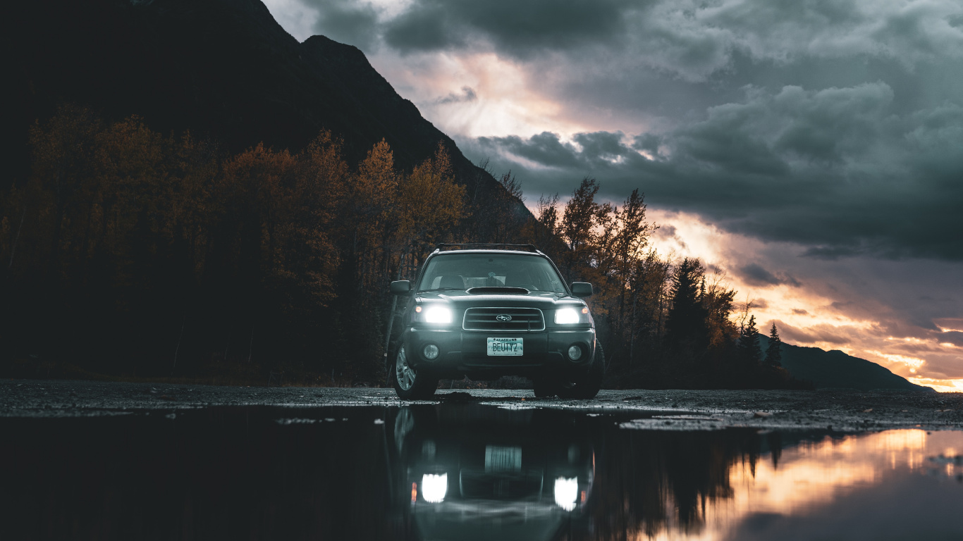 Black Car on Road Near Body of Water During Daytime. Wallpaper in 1366x768 Resolution