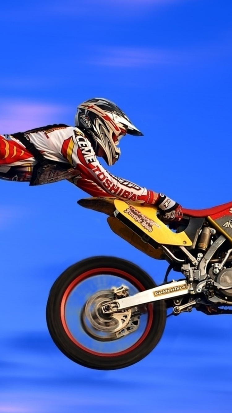 Man in Red and White Motocross Suit Riding Motocross Dirt Bike. Wallpaper in 750x1334 Resolution