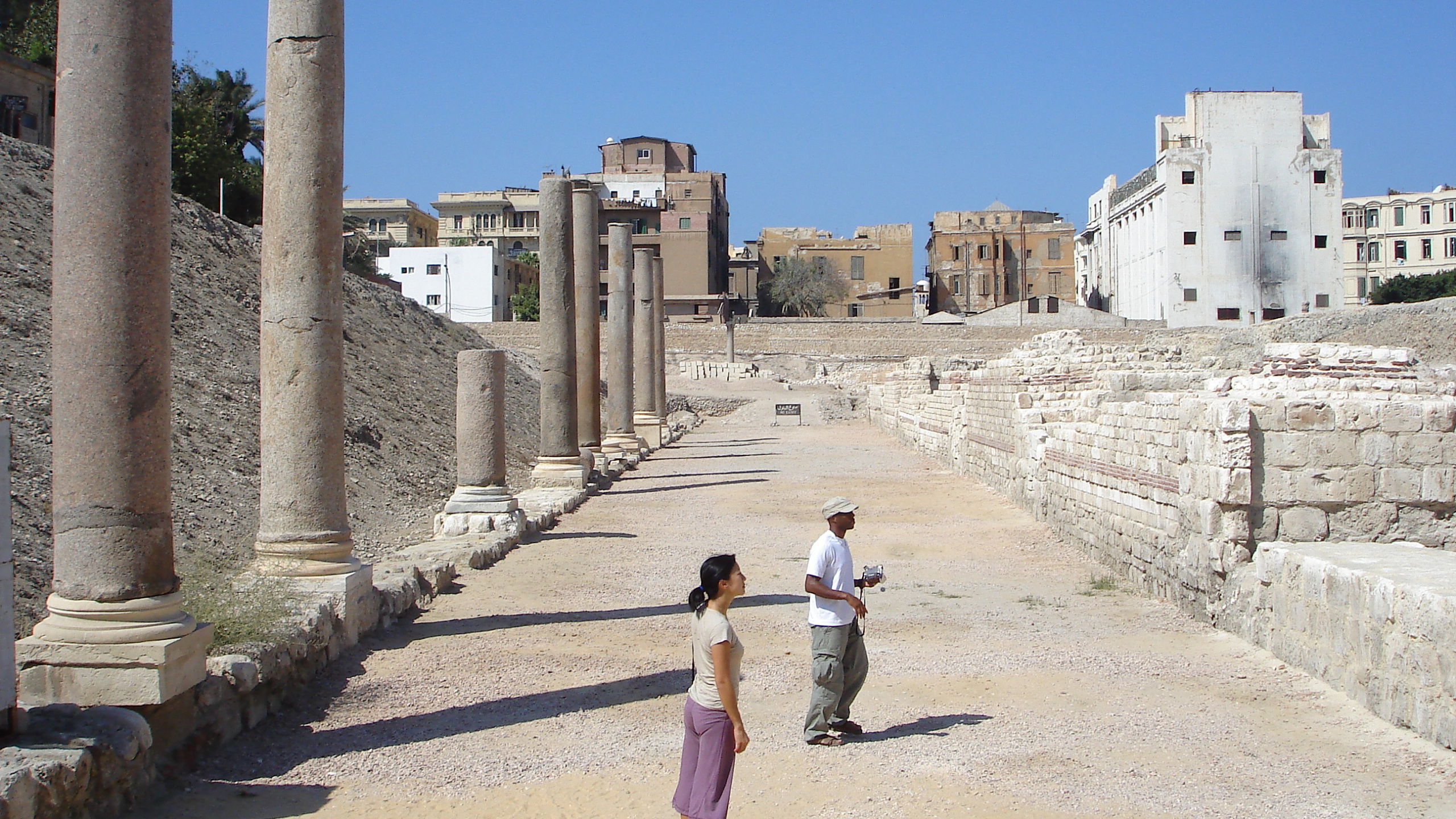 Woman in White Shirt Walking on Pathway During Daytime. Wallpaper in 2560x1440 Resolution