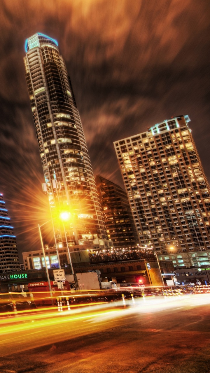 Cars on Road Near High Rise Buildings During Night Time. Wallpaper in 720x1280 Resolution