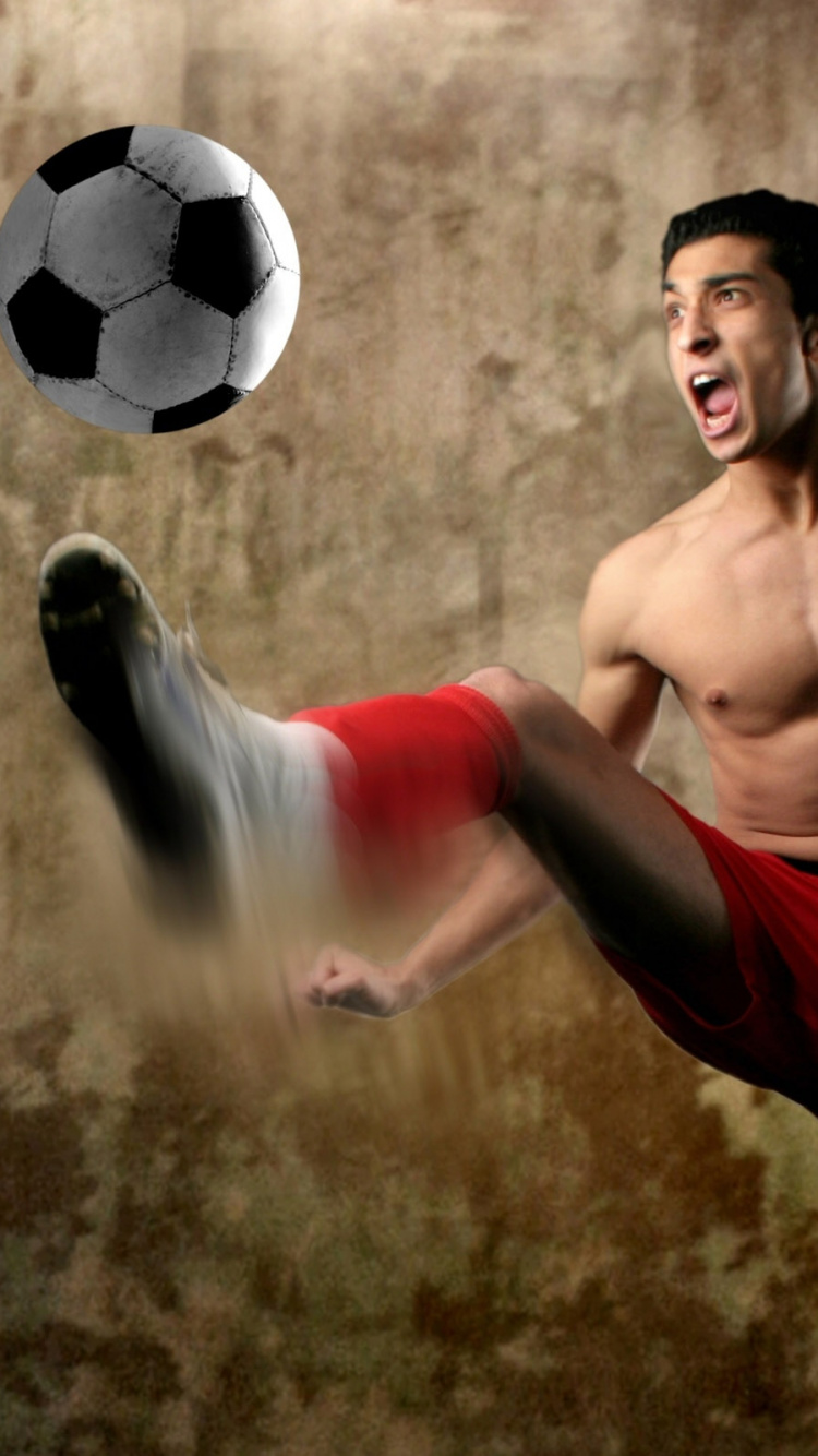 Topless Man in Red Shorts Playing Soccer Ball. Wallpaper in 750x1334 Resolution
