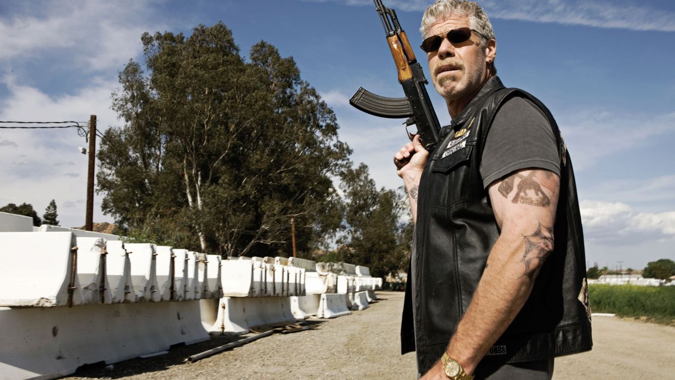 man in black button up shirt holding rifle