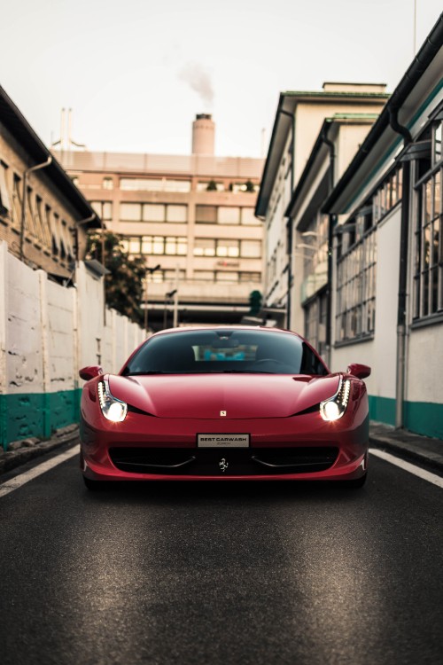 Image red ferrari 458 italia parked on sidewalk during daytime