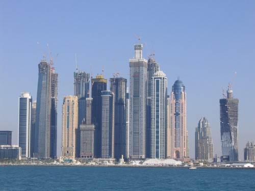 Image city skyline across body of water during daytime