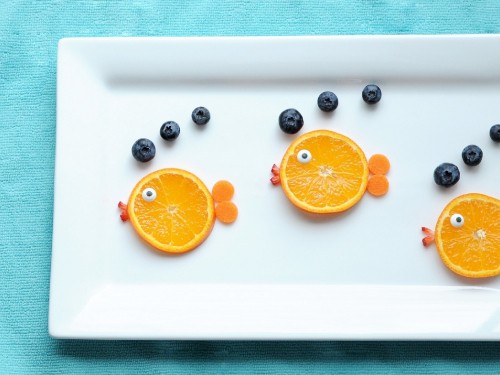 Image sliced orange fruit on white ceramic plate