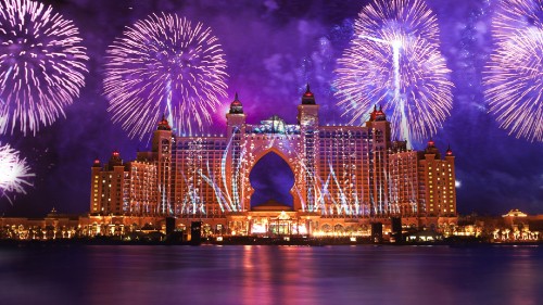 Image fireworks above city buildings during night time