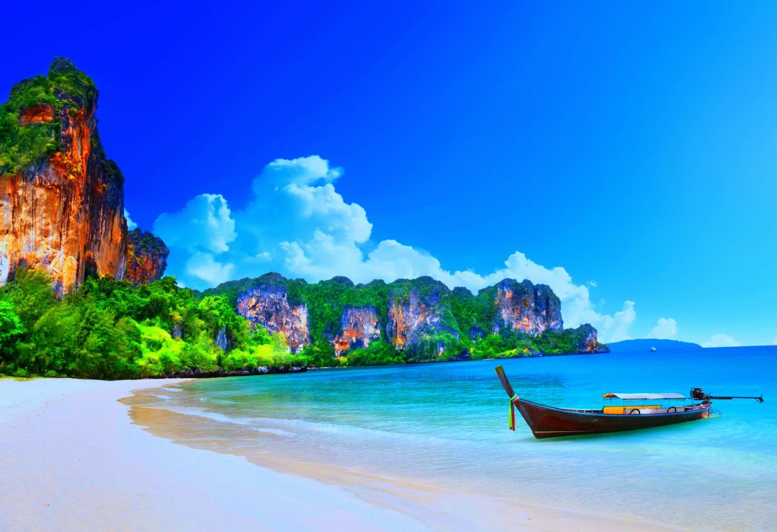 brown boat on sea shore during daytime