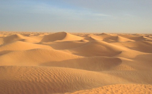 Image brown sand under blue sky during daytime