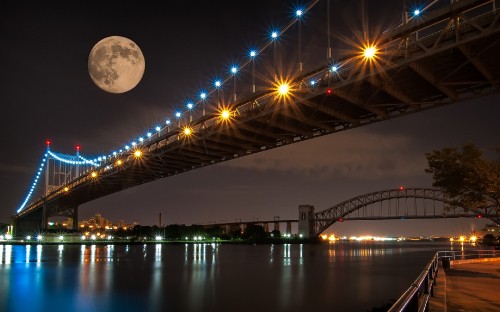 Image bridge over body of water during night time