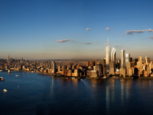 Image city skyline across body of water during daytime