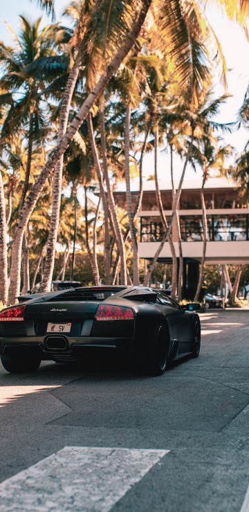 Image black porsche 911 parked on road during daytime