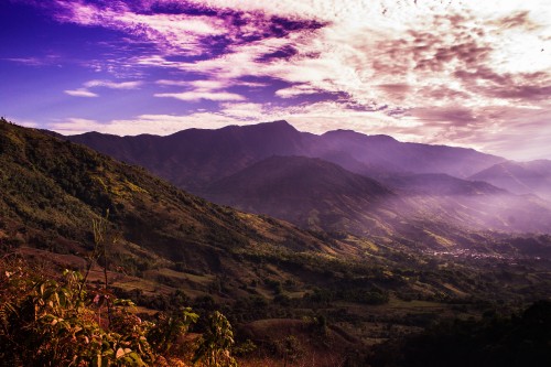 Image green and brown mountains under cloudy sky during daytime