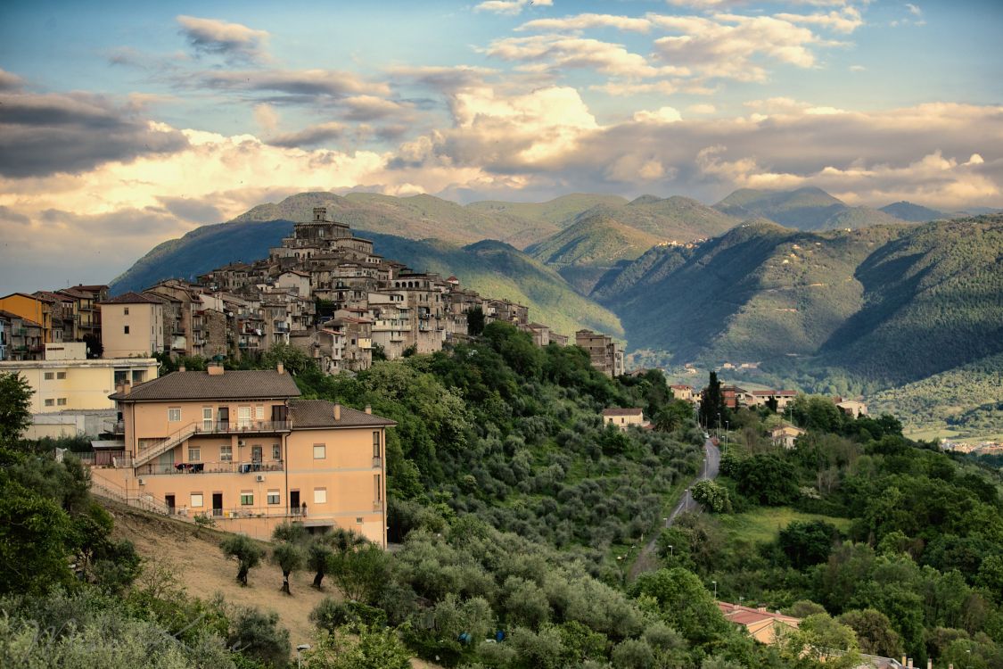 brown concrete building on top of mountain during daytime