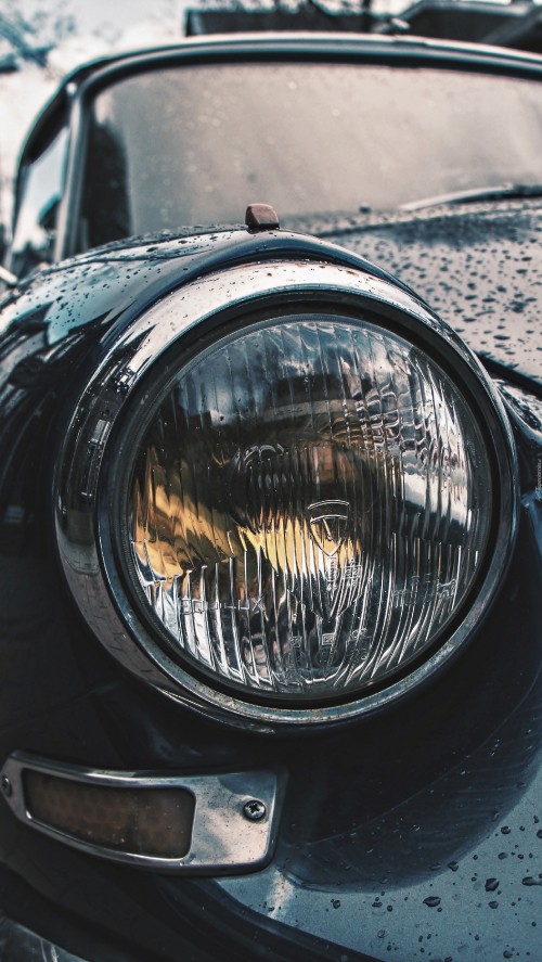 Image black car with headlight on road during daytime