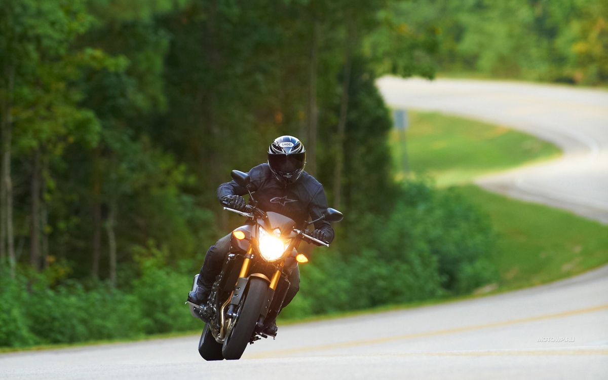 man in black helmet riding yellow motorcycle on road during daytime