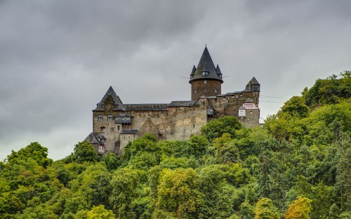 Image brown and gray concrete castle under gray cloudy sky